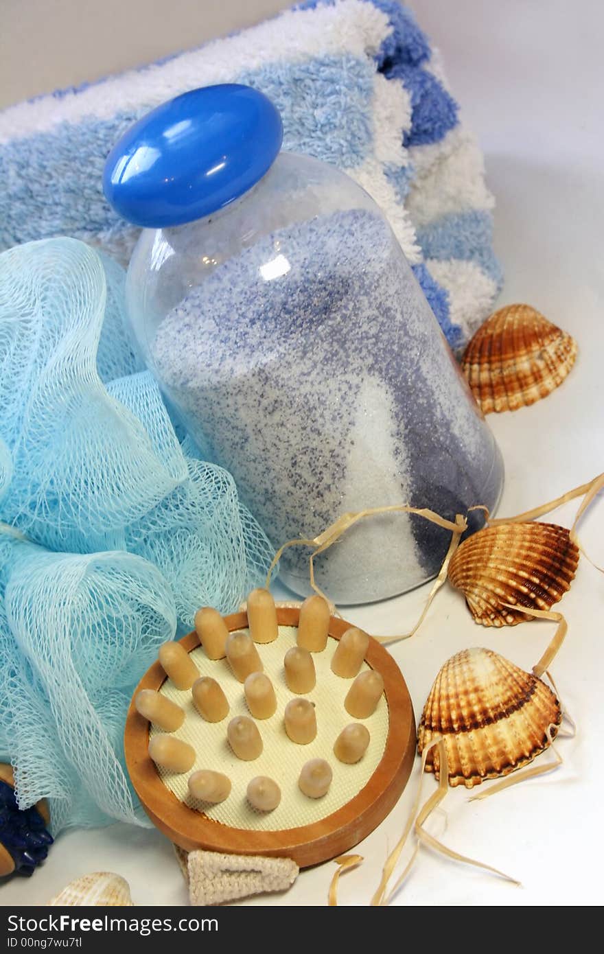 Bath salt, seashells, brush, blue towel. Bath salt, seashells, brush, blue towel