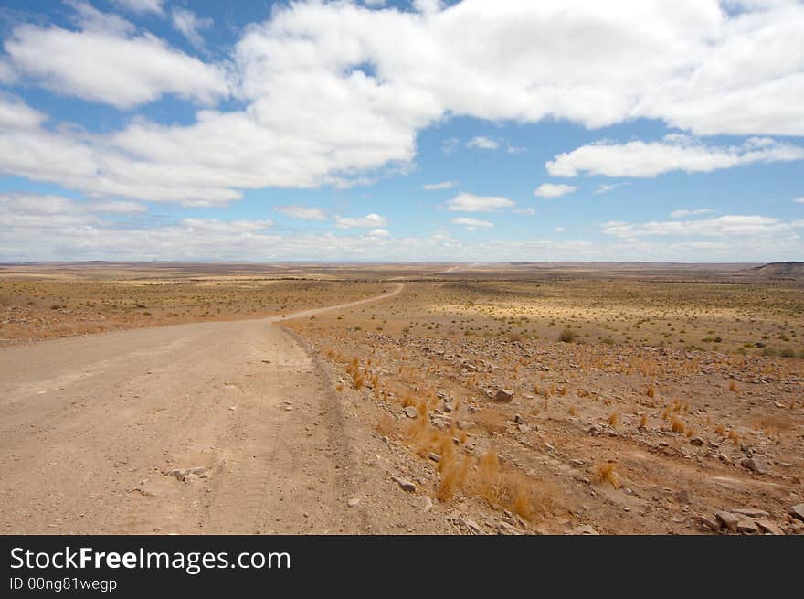 Endless gravel road into the desert. Endless gravel road into the desert