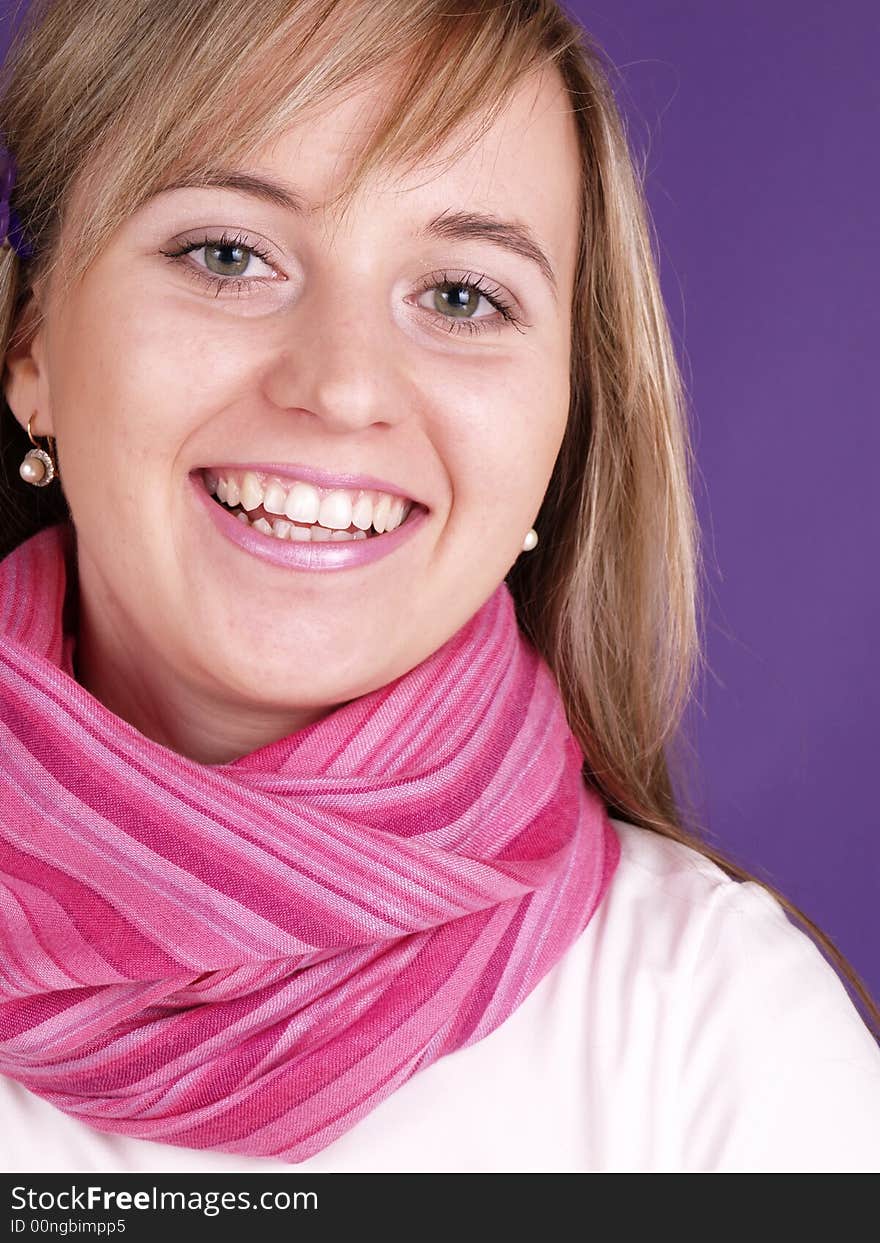 Smiling girl on the purple background