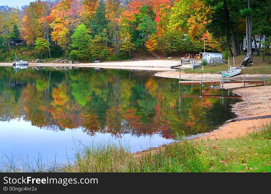 Reflection of colorful trees in water during autumn time. Reflection of colorful trees in water during autumn time