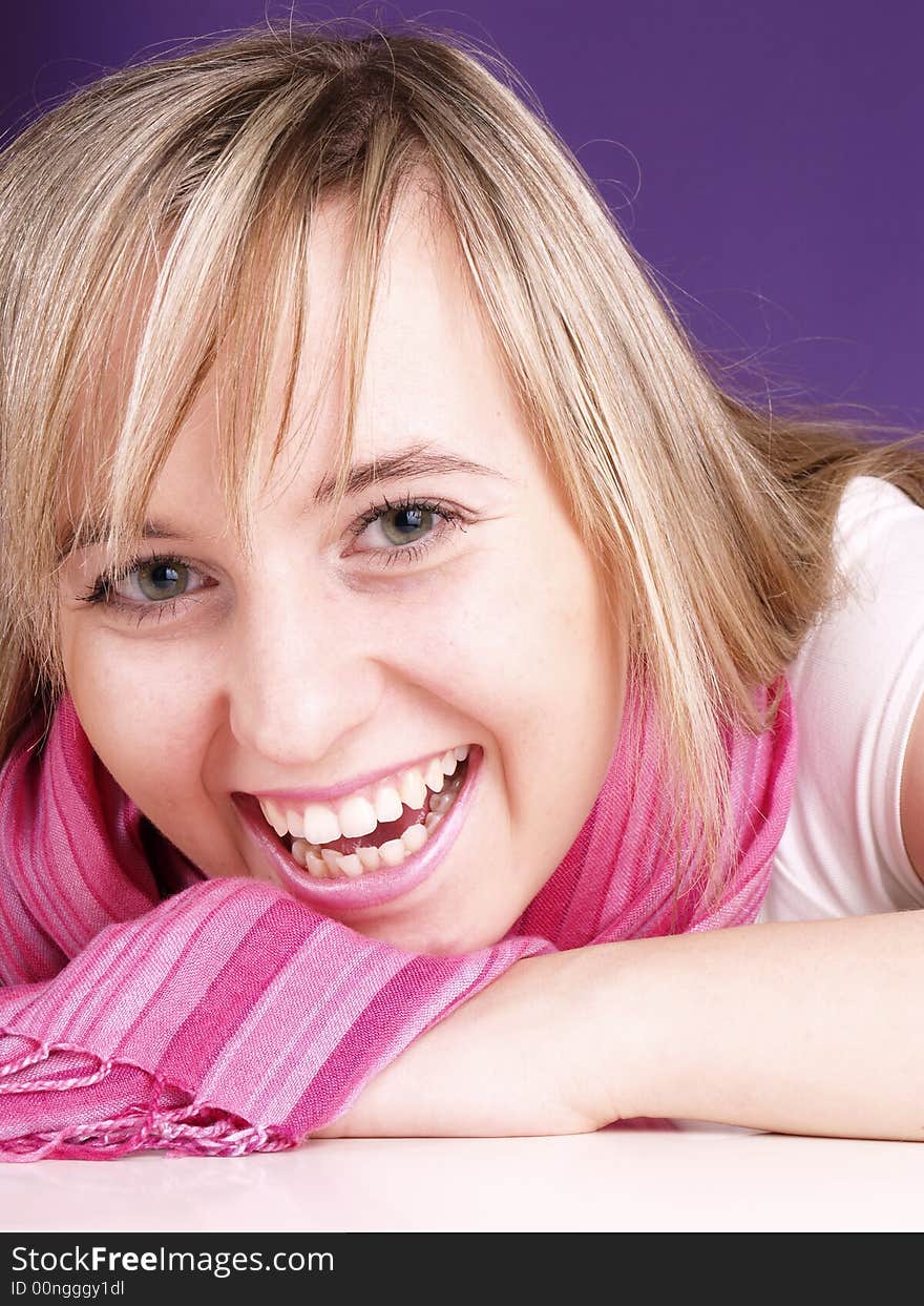 Smiling girl on the purple background