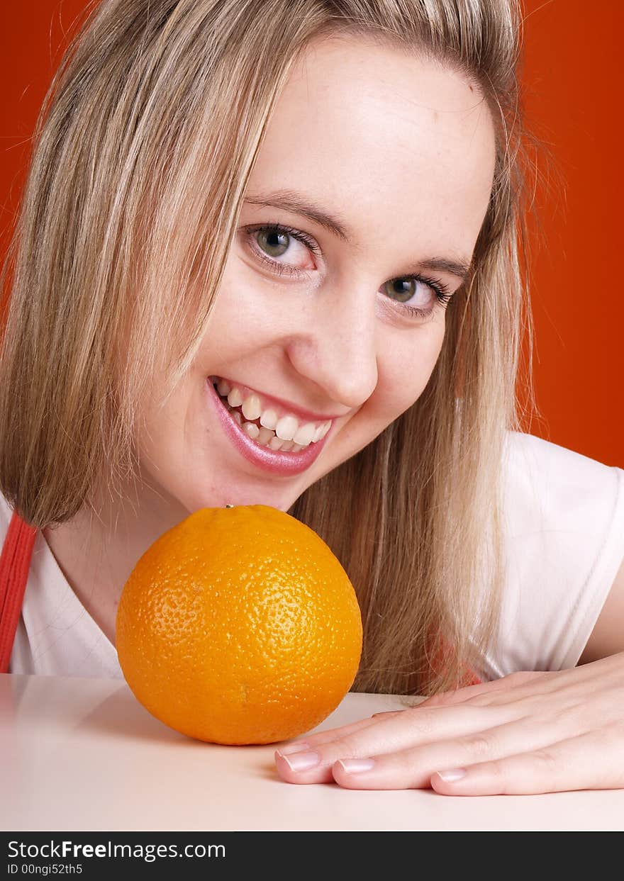 Smiling young woman with orange. Smiling young woman with orange.