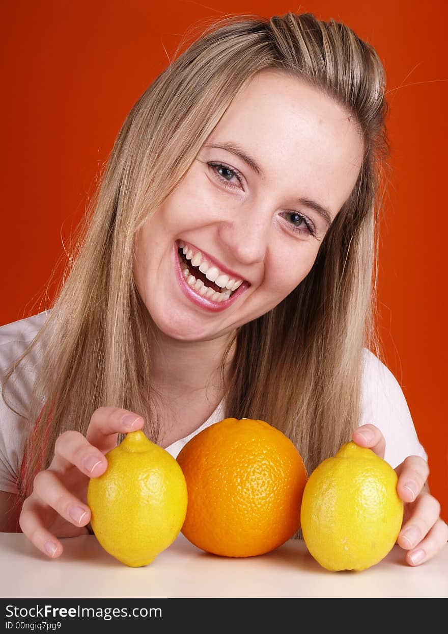 Happy young woman and fruits.