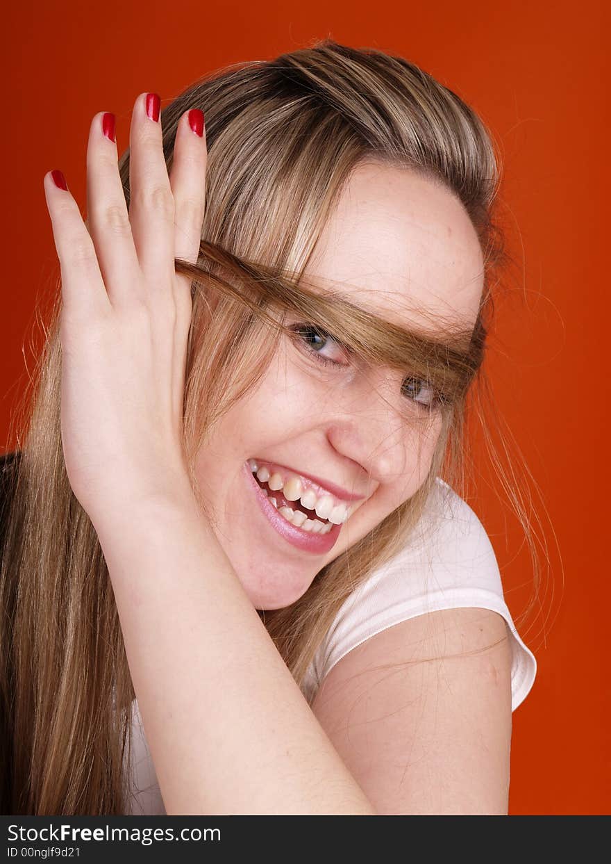 Smiling woman with hair over her face