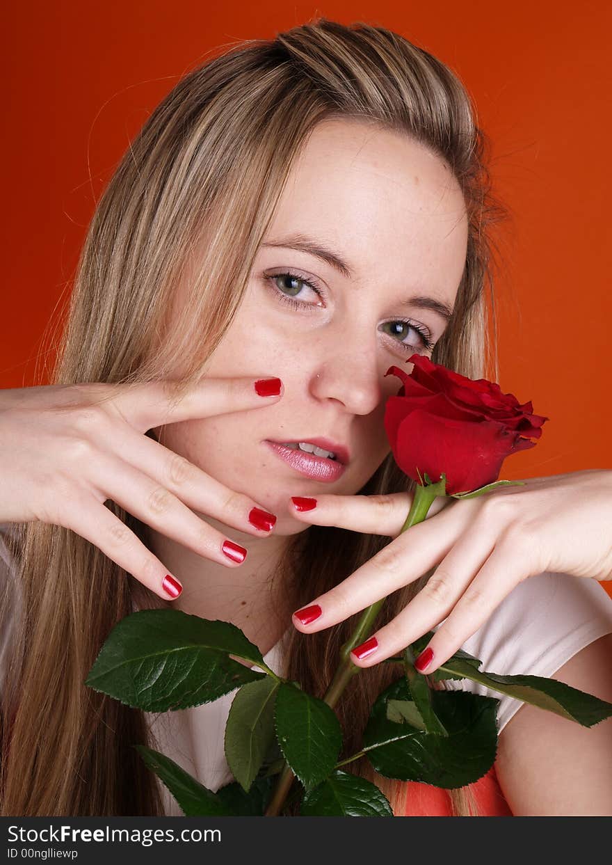 Beautiful girl in love holding a red rose