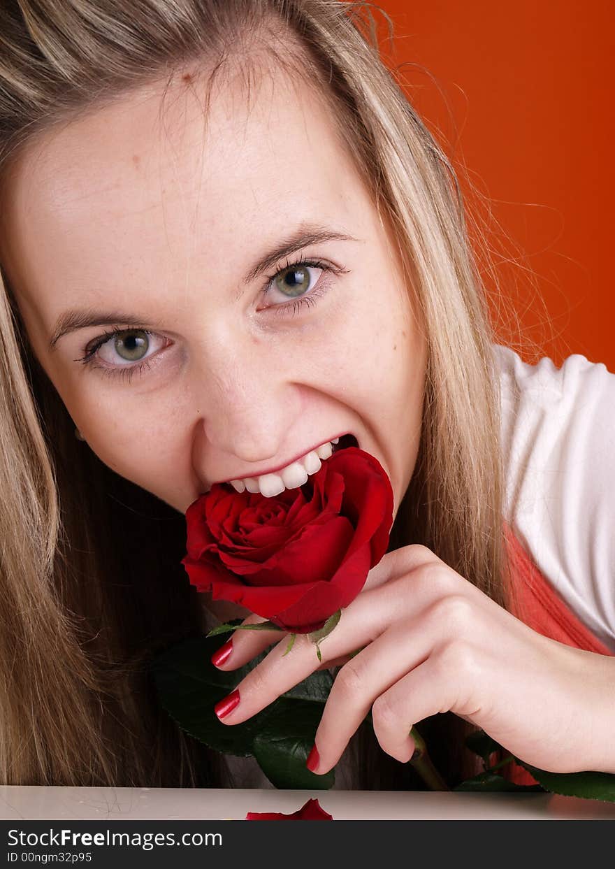 Blond girl with red rose in the mouth. Blond girl with red rose in the mouth