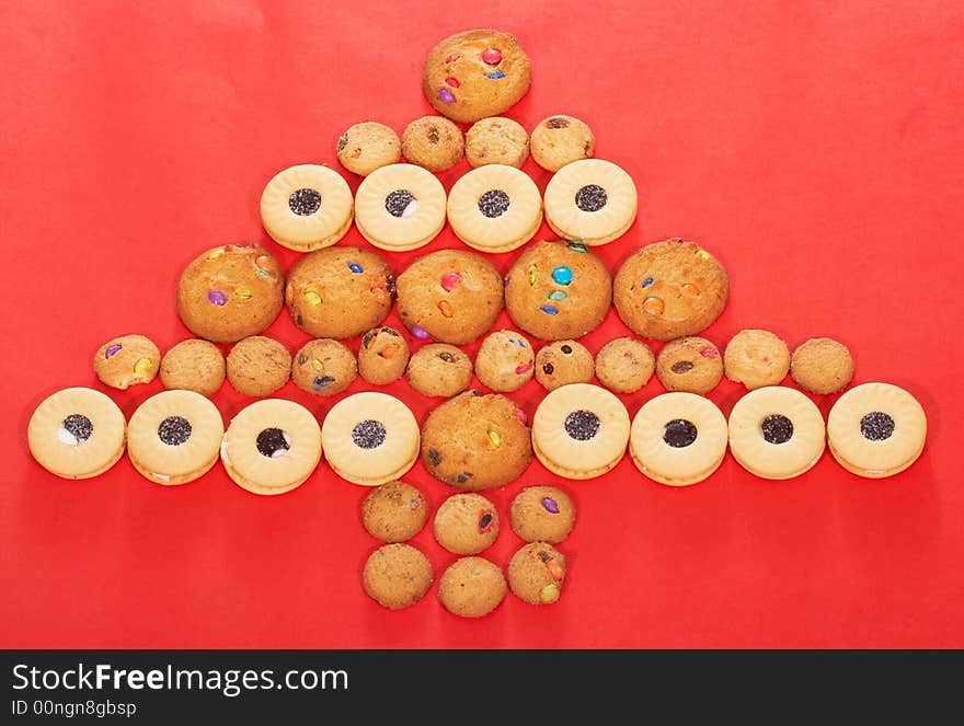 Christmas tree formed from tasty cookies on a red background. Christmas tree formed from tasty cookies on a red background