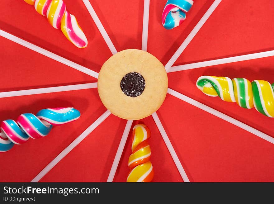 Twirl lollipop candies over a red background