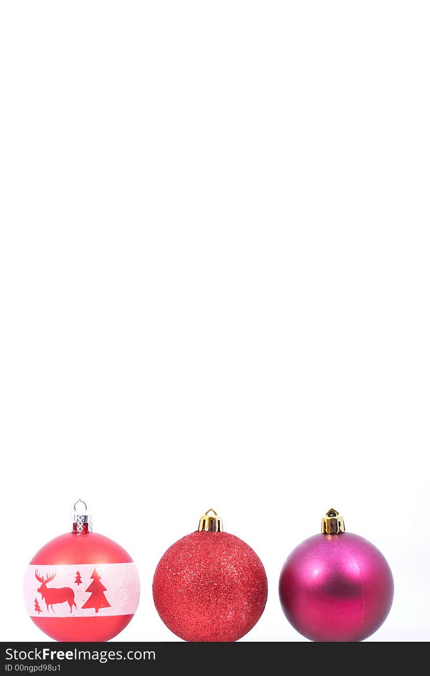 Three christmas balls over a white background