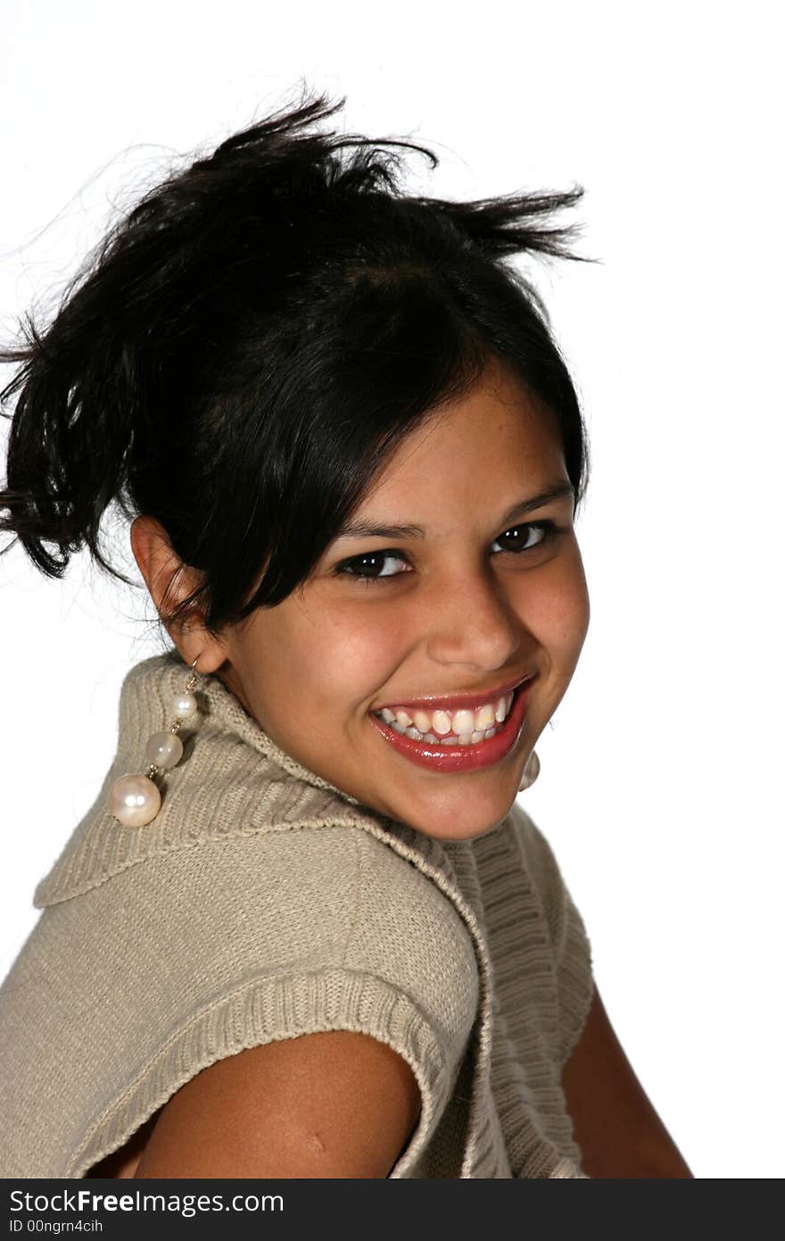 Portrait of cute young Hispanic woman wearing a beige sweater with her long black hair up. Portrait of cute young Hispanic woman wearing a beige sweater with her long black hair up