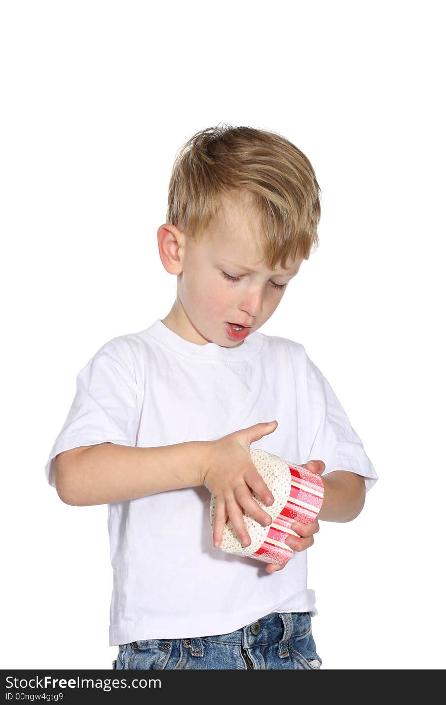 Cute toddler boy trying to open a gift box. Cute toddler boy trying to open a gift box