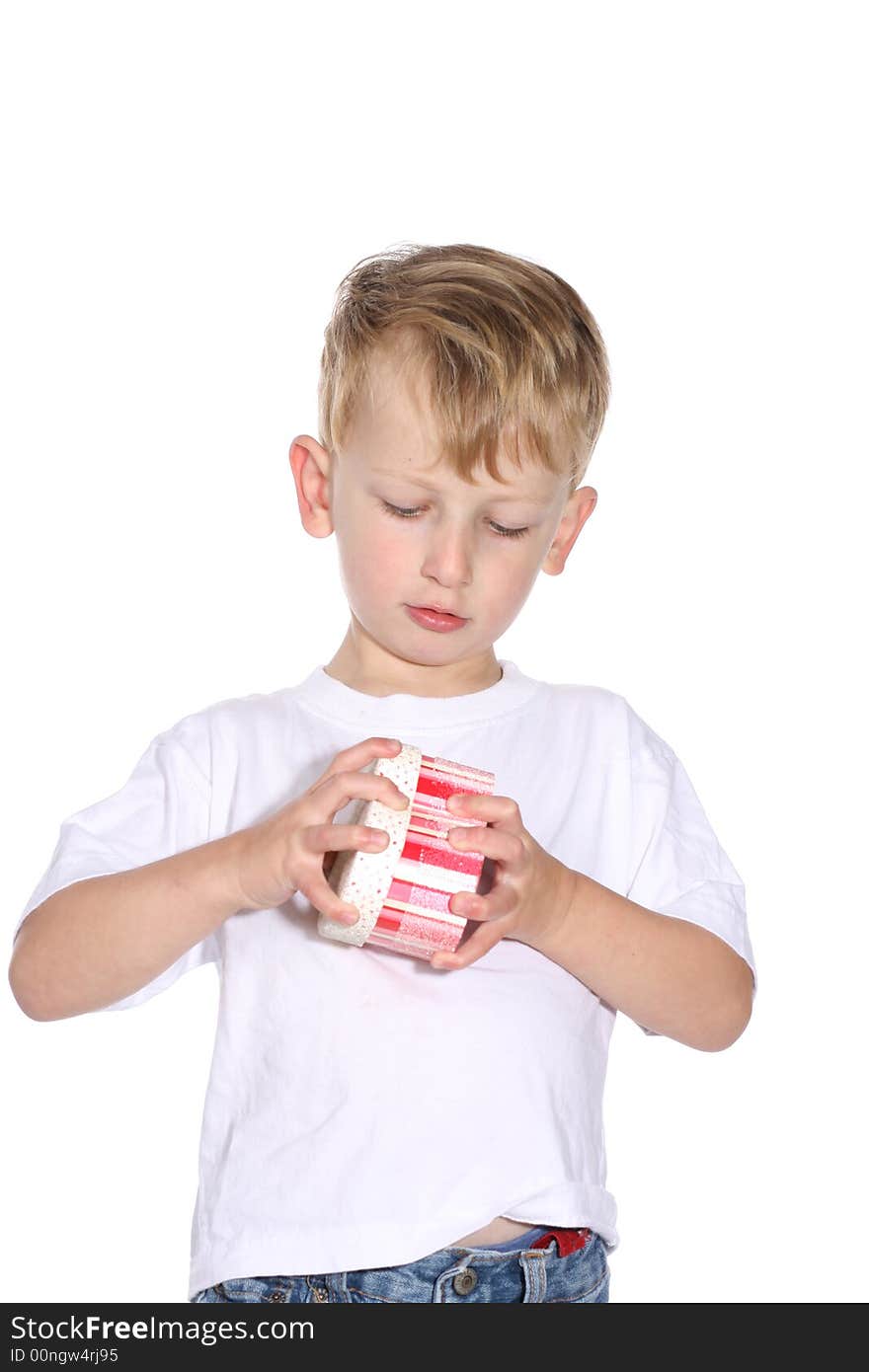 Cute toddler boy trying to open a gift box. Cute toddler boy trying to open a gift box