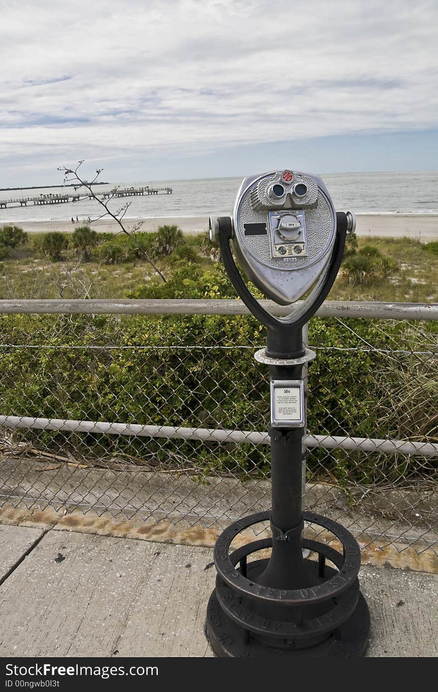 Coin op binoculars with scenic beach vista in background at Fort Desoto in Florida. Coin op binoculars with scenic beach vista in background at Fort Desoto in Florida