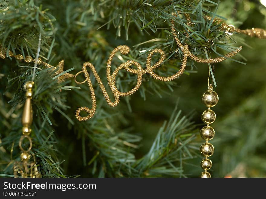 Macro of Christmas' decoration against a christmas' tree background