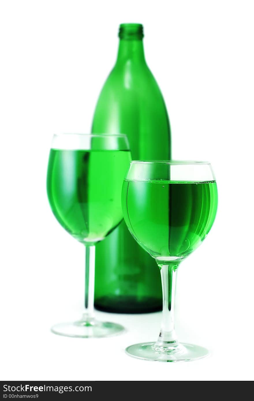 Green drink bottle and glasses over white background