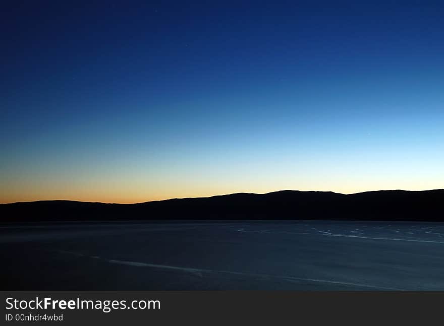 Night Baikal lake with rocks behind. Long exposure. Night Baikal lake with rocks behind. Long exposure.