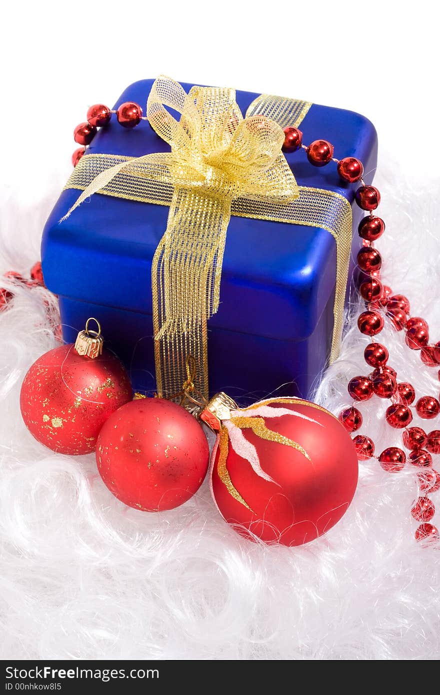 Red christmas balls and red beads, blue box with gift. Red christmas balls and red beads, blue box with gift