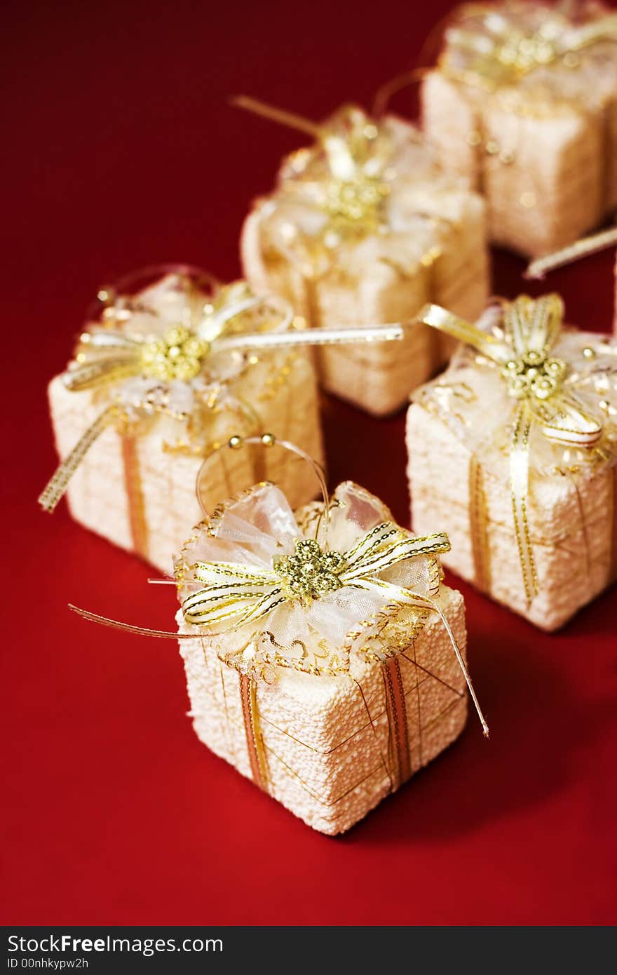 Small boxes with gifts on red background, low DOF. Small boxes with gifts on red background, low DOF