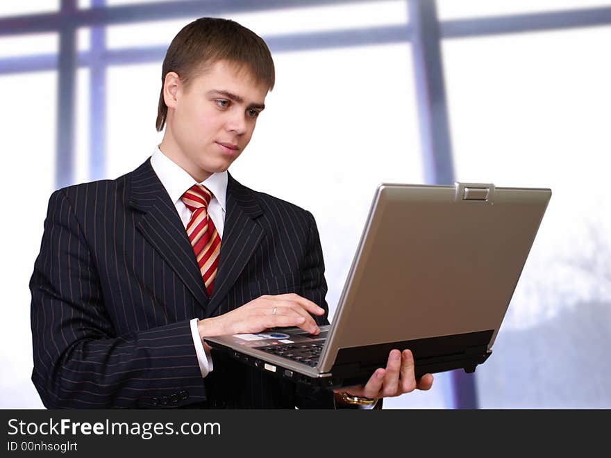 Cheerful businessman with laptop computer