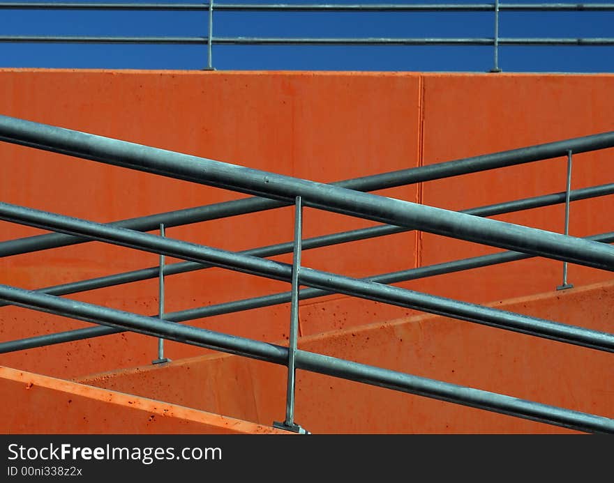 Handrail and a orange wall. Handrail and a orange wall