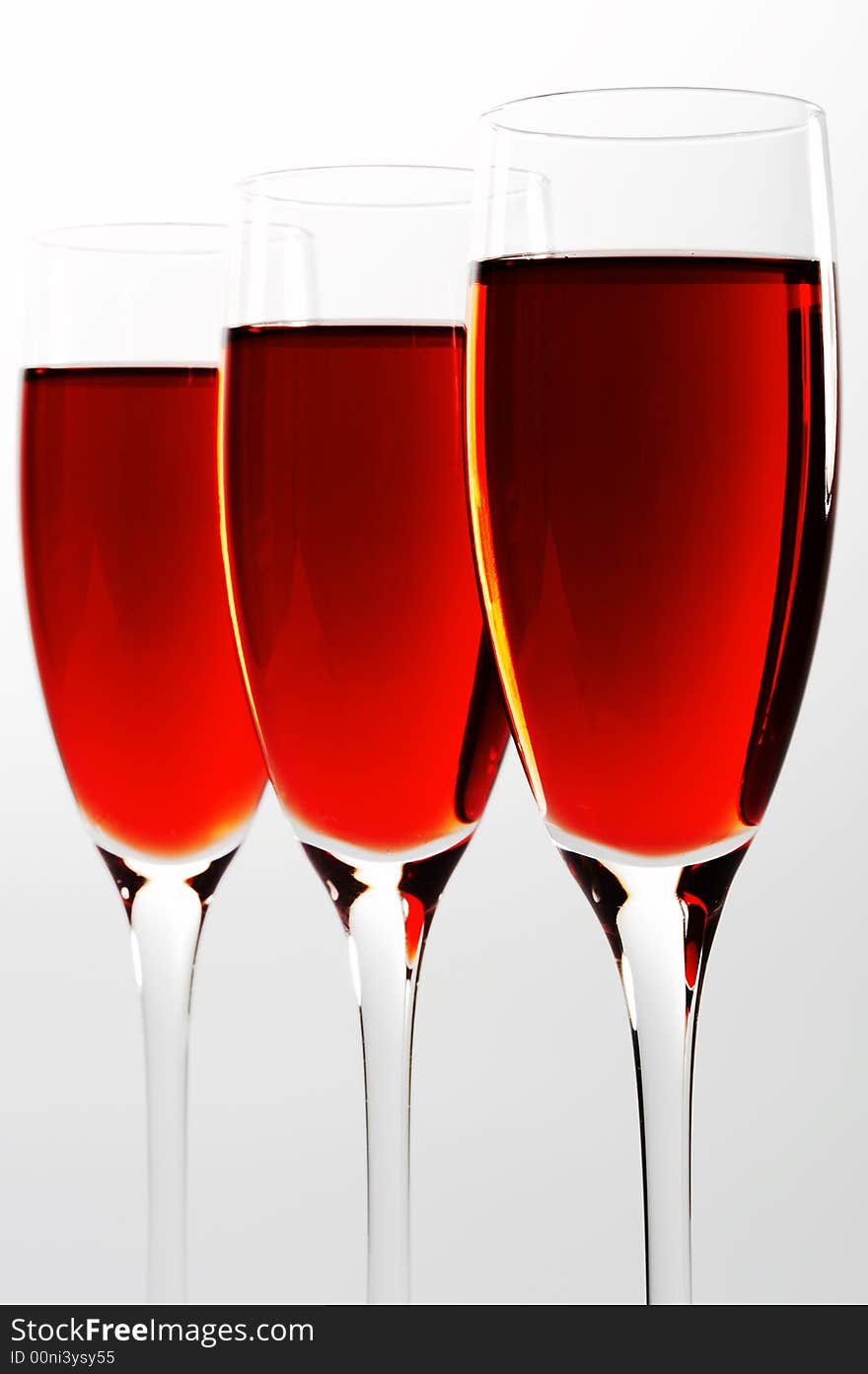 Three high and beautiful glasses with red wine