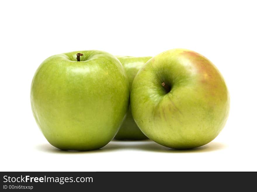 Three green apples on the white background