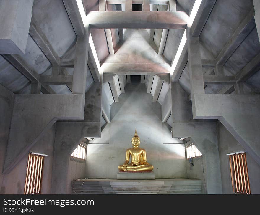 Standing golden Buddha image on the meditation institute.