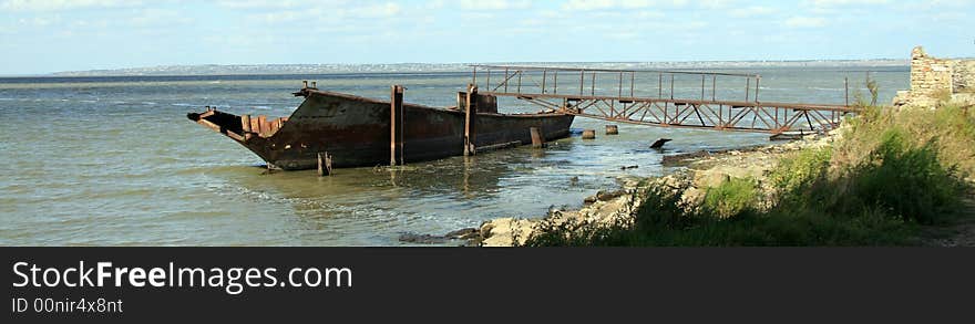 Lonely rusty ship on the lake