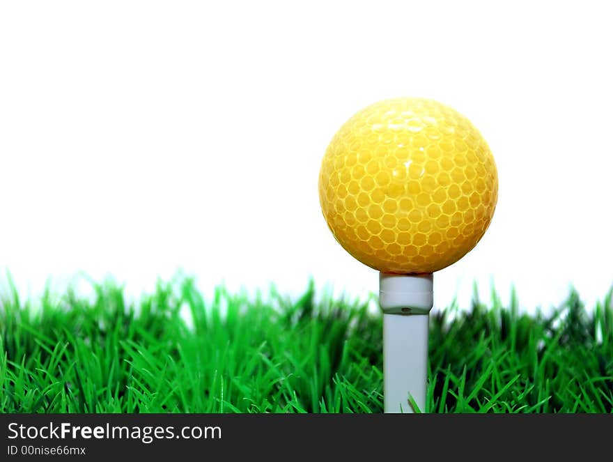 White golfball in orange tee, green fairway, isolated on white background. White golfball in orange tee, green fairway, isolated on white background