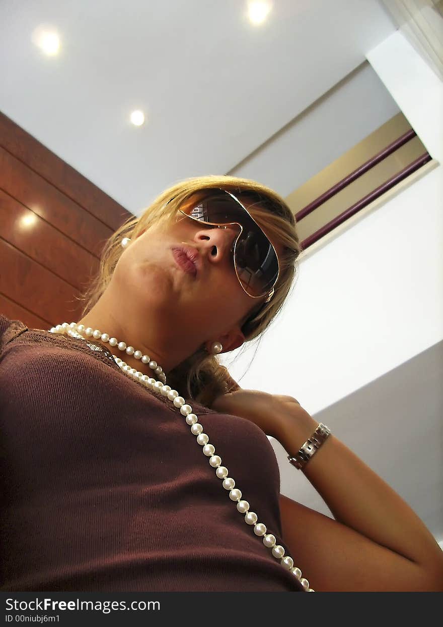 Young Girl with a necklace and sunglasses. Young Girl with a necklace and sunglasses