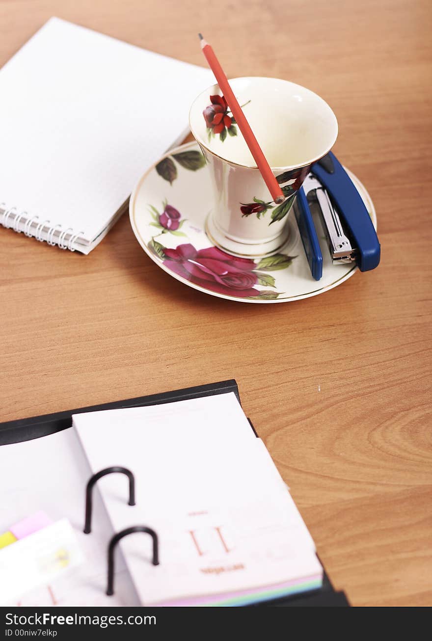 Orange pencil, notes holder and coffee cup. Orange pencil, notes holder and coffee cup