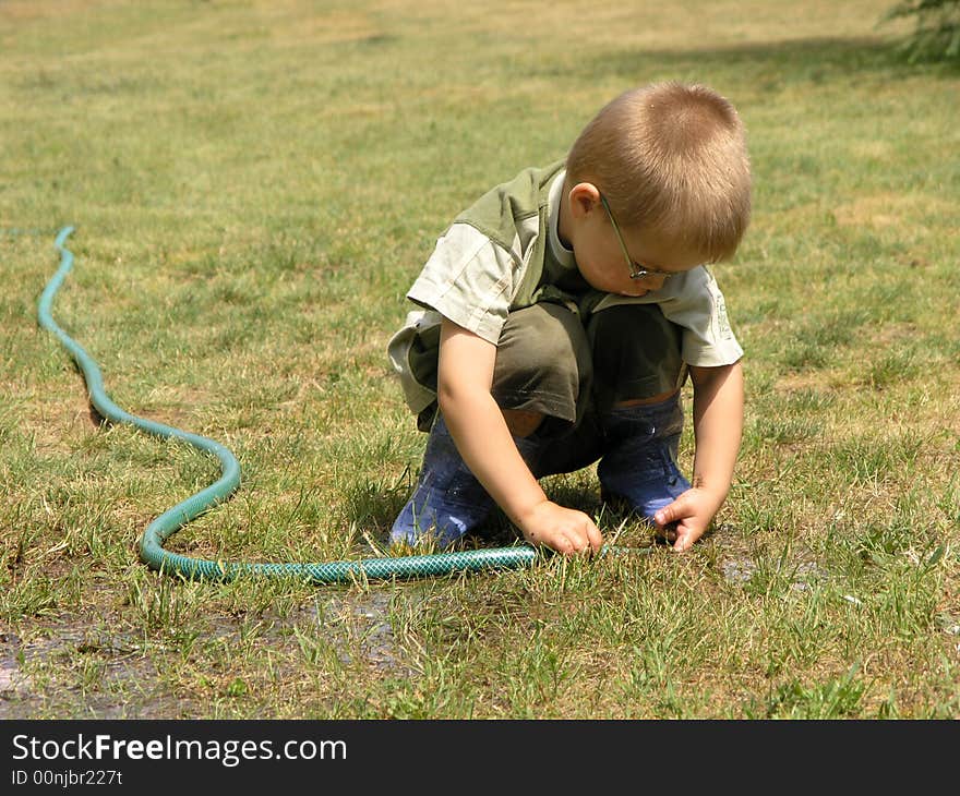 Boy plays with tools in the garden. Boy plays with tools in the garden