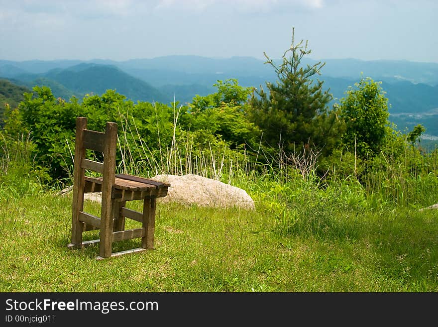 Retro wooden chair located at mountain cliff. Retro wooden chair located at mountain cliff