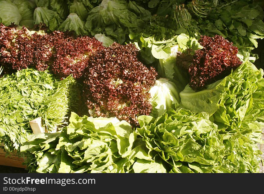 Red and green lettuce on a market stall