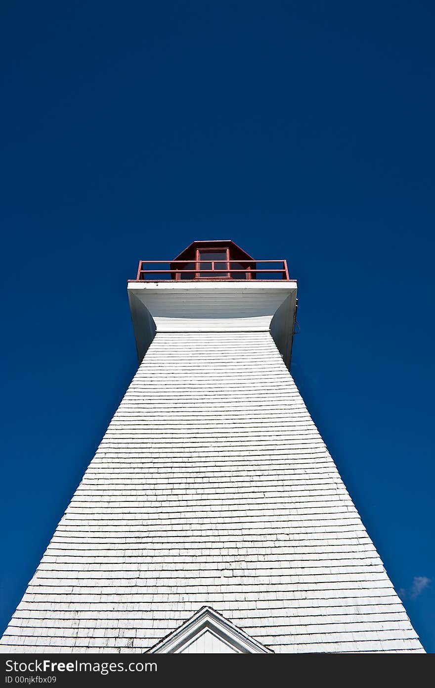 Upward shot of lighthouse with blue skies - great contrast of texture and colour. Upward shot of lighthouse with blue skies - great contrast of texture and colour