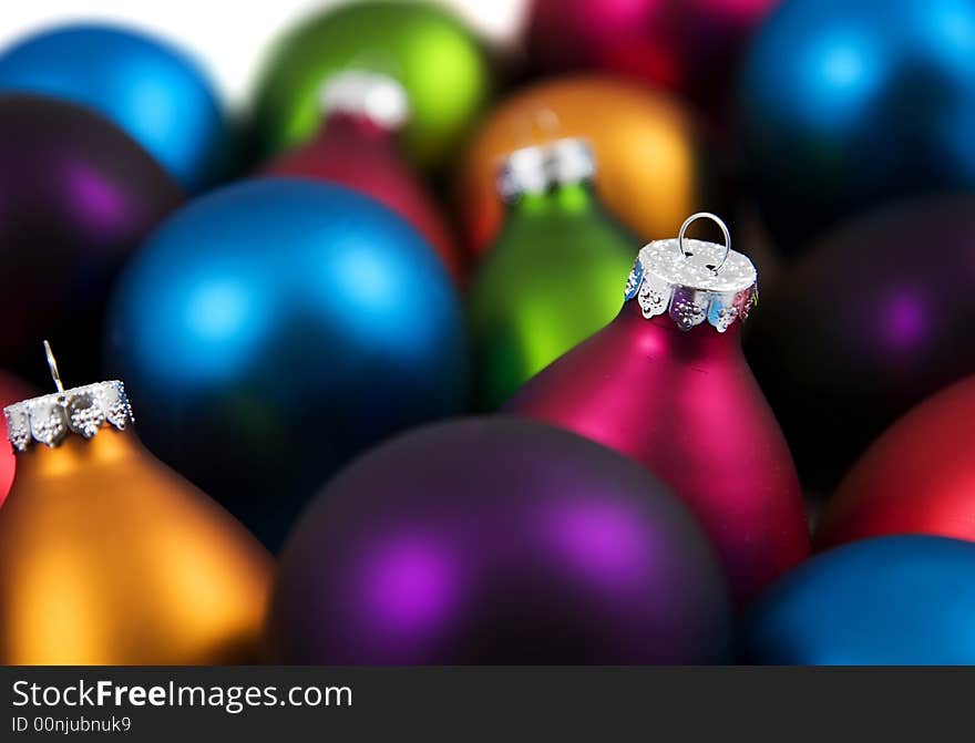 A bunch of very brightly colored christmas ornaments. A bunch of very brightly colored christmas ornaments