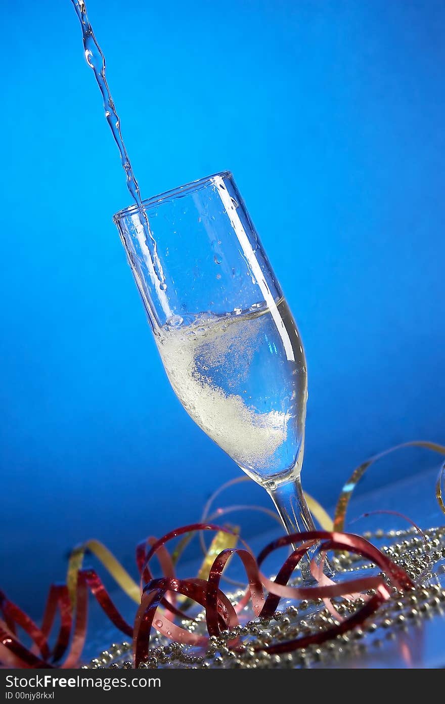 Still life with glass with champagne on the blue background