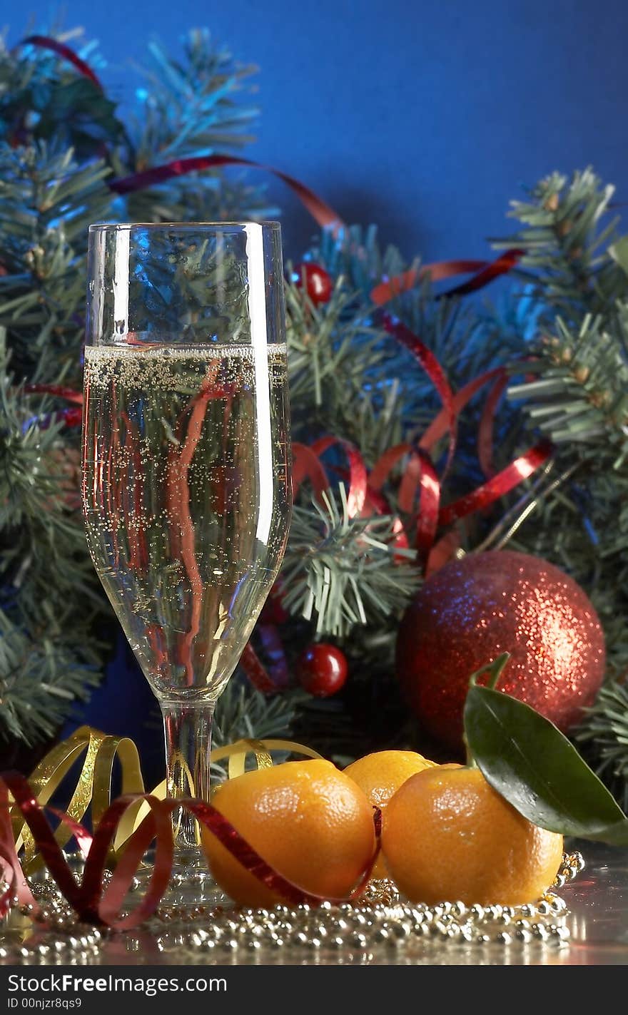 Still life with glass with champagne on the blue background