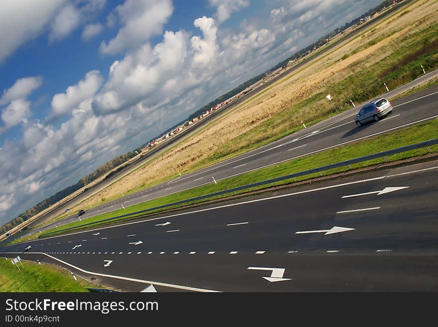 Two lane motorway under cloudy sky (tilt view). Two lane motorway under cloudy sky (tilt view)