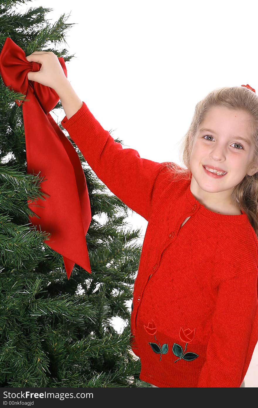 Young child hanging bow on tree smile