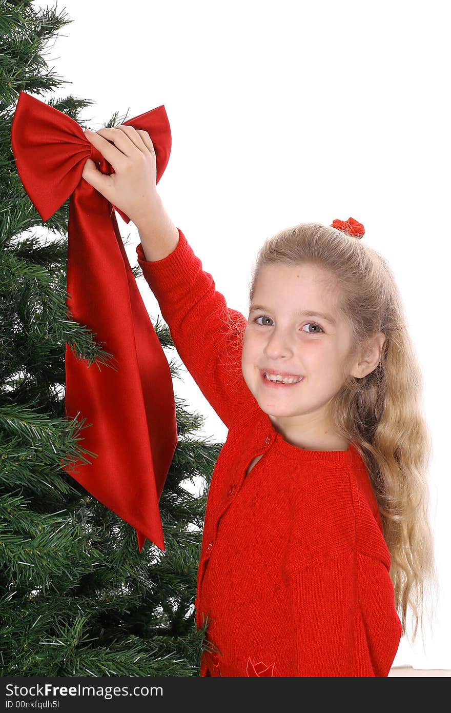 Young child hanging bow on tree