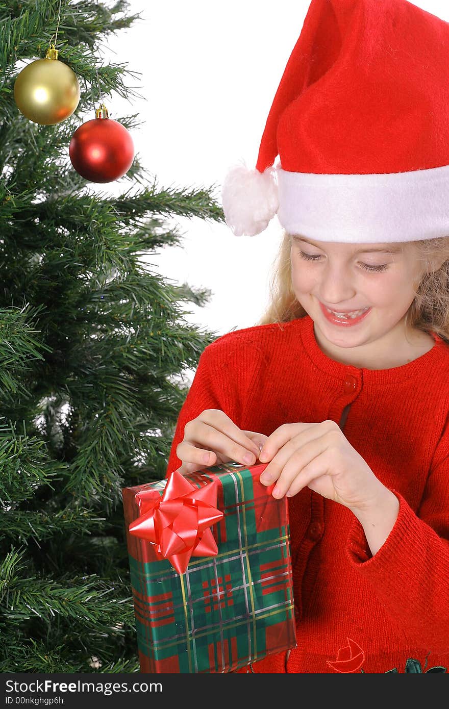 Child with present by christmas tree