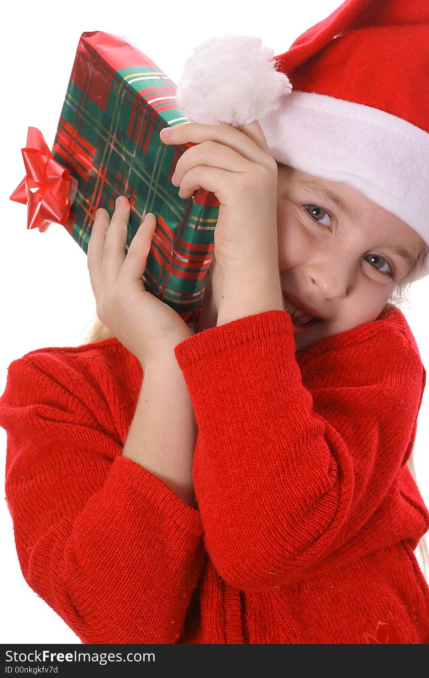 Photo of a Little girl shakin a present vertical