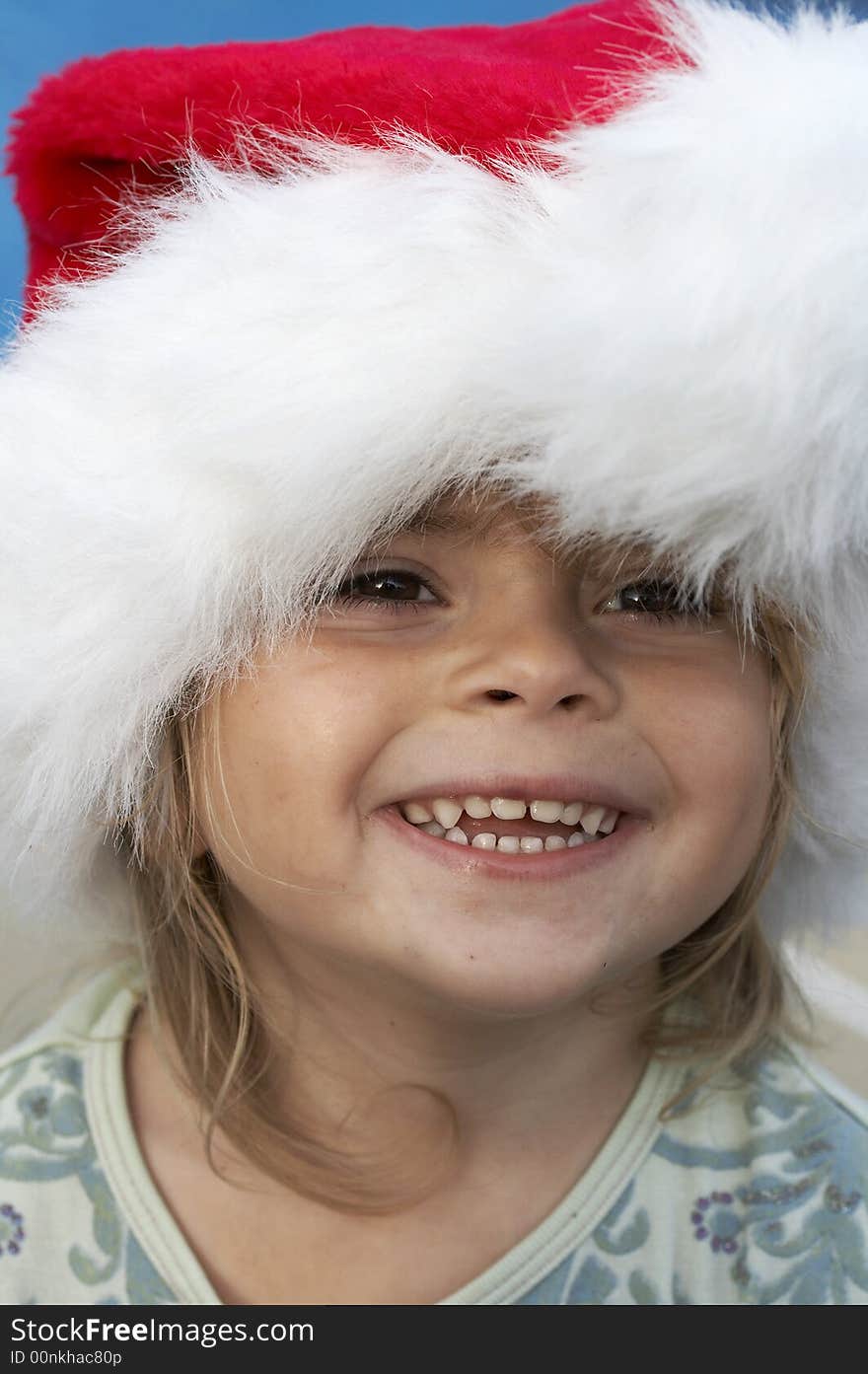 A young girl smiling in santa hat. A young girl smiling in santa hat