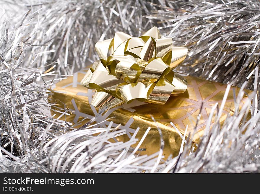 Golden gift with ribbons and decorative star