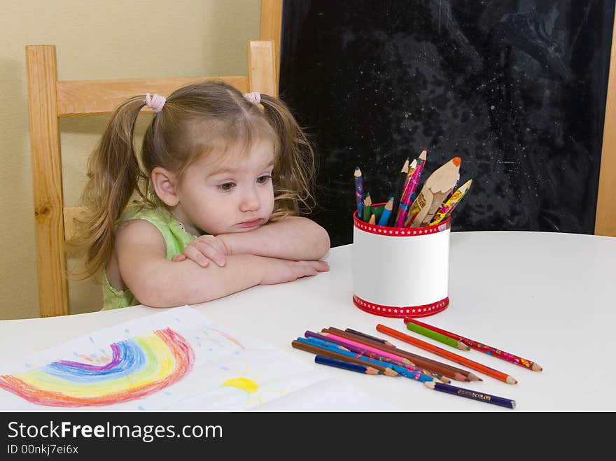 Small pretty girl has drawn a rainbow