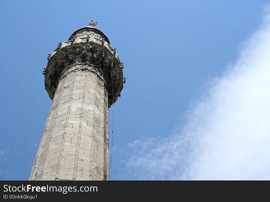 A minaret* of a mosque**  from below

* tall tower with a balcony that is attached to a Muslim mosque from which the people are called to prayer 

** Muslim house of prayer and worship. A minaret* of a mosque**  from below

* tall tower with a balcony that is attached to a Muslim mosque from which the people are called to prayer 

** Muslim house of prayer and worship