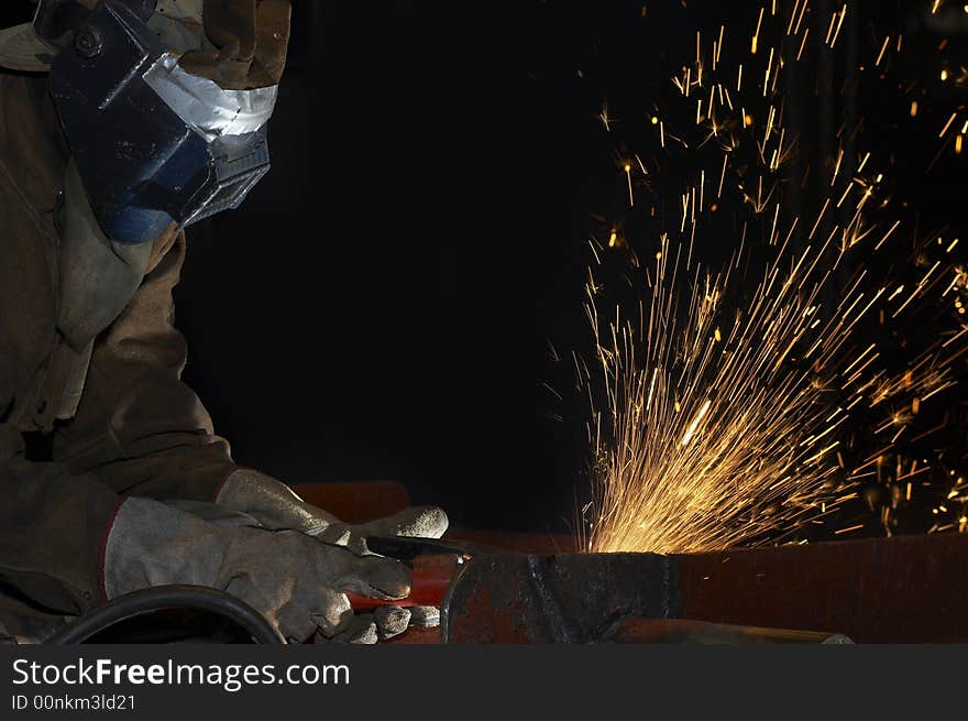 An arc welder spraying a lot of fire. An arc welder spraying a lot of fire