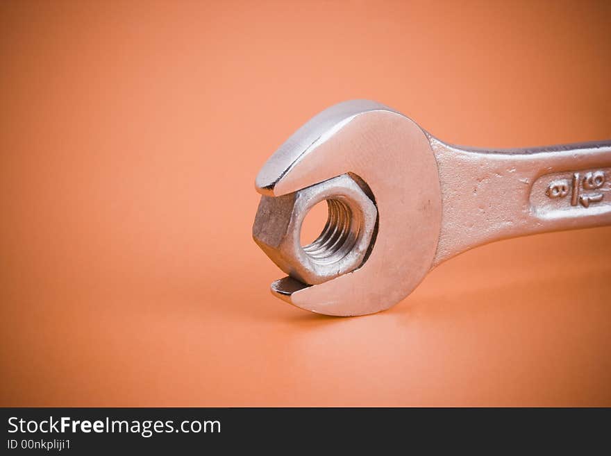 Closeup of a wrench holding a nut. Closeup of a wrench holding a nut.