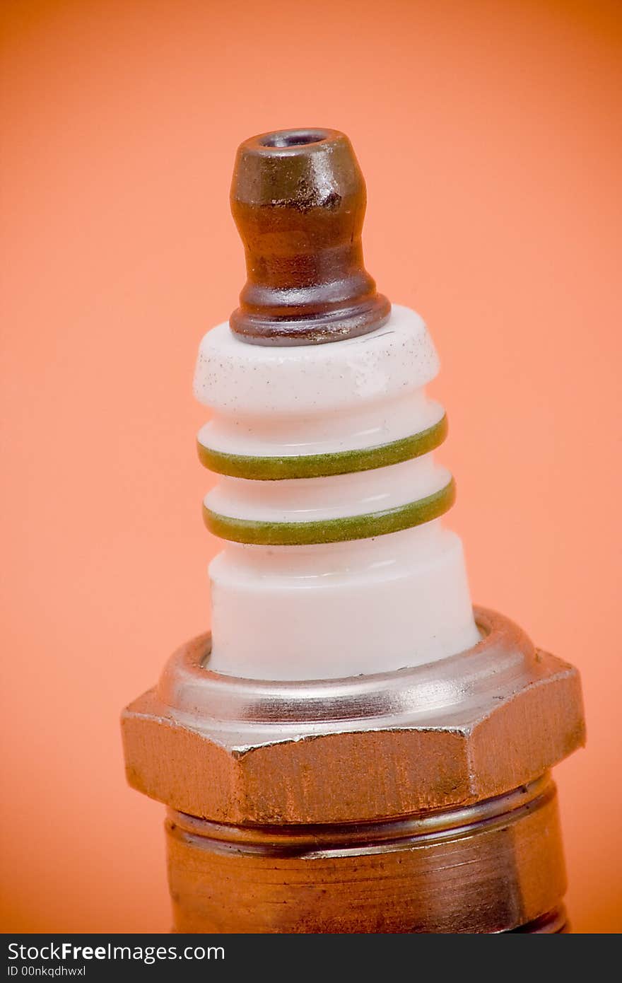 Closeup of the top of a spark plug.